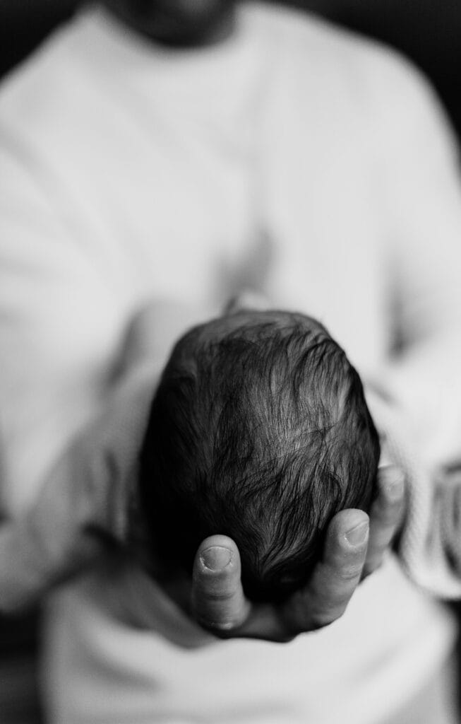 Close-up of a Father Holding His Newborn Baby