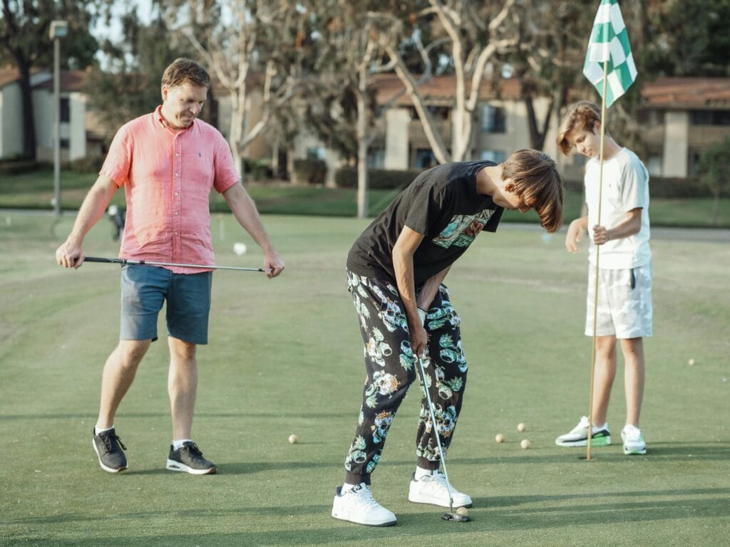 Father and Sons Playing Golf