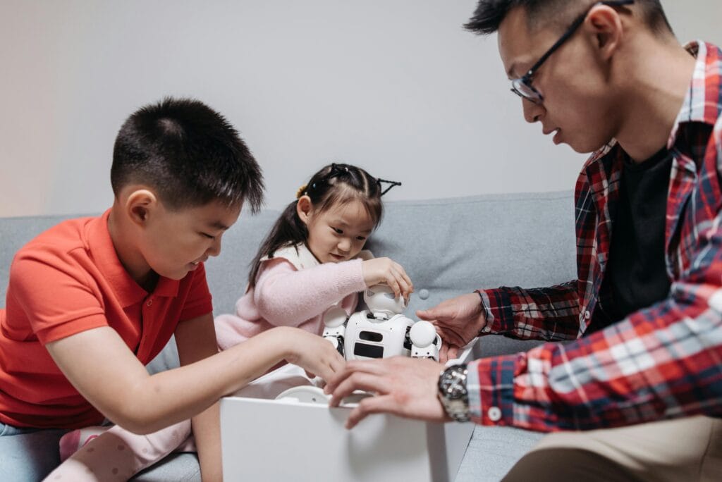 A happy family unboxing a robot toy together indoors, highlighting joyful moments.